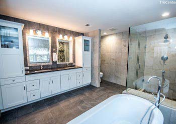 Bathroom remodel with black countertop and shower glass doors